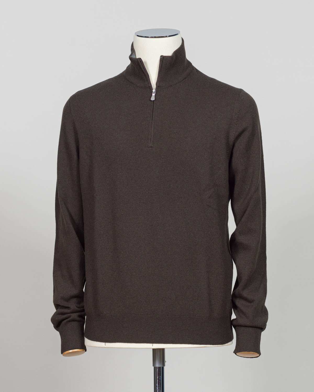 Gran Sasso Half-Zip Knit in rich dark brown, a timeless layering essential for the refined wardrobe. This Italian-crafted piece offers sophisticated simplicity with a comfortable half-zip construction, perfect for transitional styling. The knit's subtle texture and classic colorway pair effortlessly with tailored trousers or casual wear. Expertly finished with attention to detail throughout, this sweater delivers understated elegance and versatility season after season.