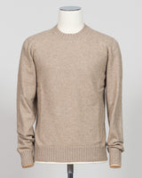 A light beige crewneck knit sweater displayed on a white mannequin torso against a light gray studio background. Italian craftsmanship meets luxurious comfort in this Gran Sasso felted cashmere crewneck. The substantial weight and refined texture of premium cashmere deliver warmth without bulk, while the timeless silver tone pairs effortlessly with tailored trousers or structured outerwear. A foundational piece for the wardrobe—versatile enough for layering, refined enough to stand alone. Gran Sasso