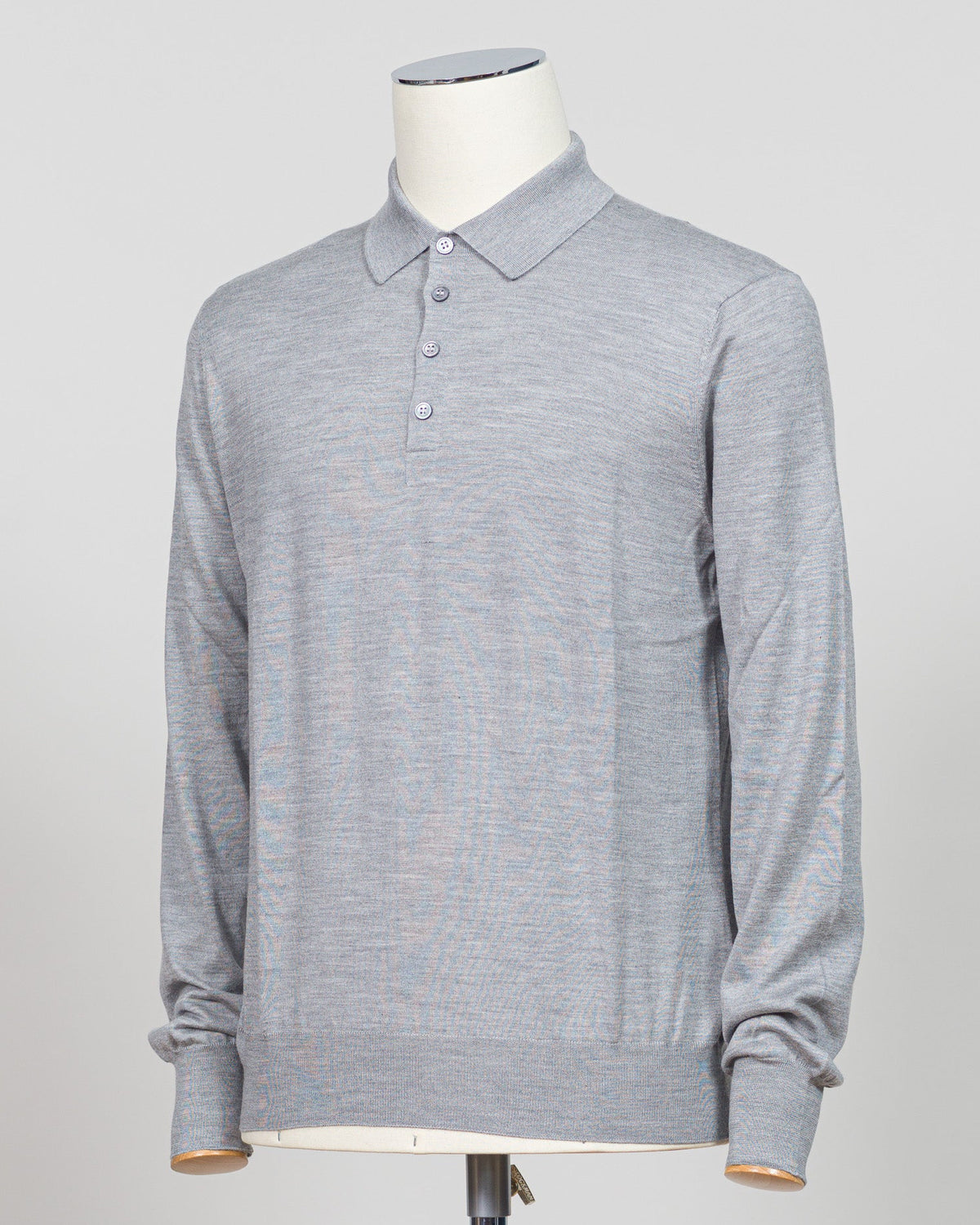 Refined elegance meets tactile luxury in this Gran Sasso polo, crafted from a sophisticated blend of wool, cashmere, and silk. The silver tone offers understated versatility across seasons, while the premium fiber composition delivers exceptional softness and breathability. A timeless essential for the discerning wardrobe. Gran Sasso Wool Cashmere & Silk Polo / Silver