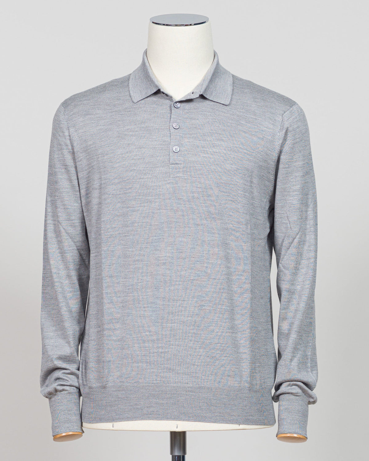 Refined elegance meets tactile luxury in this Gran Sasso polo, crafted from a sophisticated blend of wool, cashmere, and silk. The silver tone offers understated versatility across seasons, while the premium fiber composition delivers exceptional softness and breathability. A timeless essential for the discerning wardrobe. Gran Sasso Wool Cashmere & Silk Polo / Silver