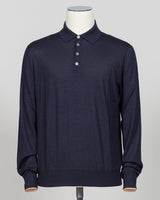 A dark navy blue long-sleeve polo shirt displayed on a white mannequin torso against a light gray background.  Italian craftsmanship meets refined versatility. This Gran Sasso polo blends wool, cashmere, and silk for a lightweight, luxurious knit that transitions effortlessly from casual to elevated dressing. The navy colorway pairs with virtually any tailoring. Premium construction and natural fiber content ensure durability and comfort across seasons. Gran Sasso Wool Cashmere &amp; Silk Polo / Navy