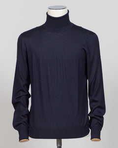 Refined luxury knitwear from Gran Sasso, combining wool, cashmere, and silk in a timeless roll neck silhouette. The navy colorway offers versatile sophistication—equally at home layered under tailoring or worn as a standalone piece. Soft, breathable construction ensures comfort across seasons, while the blend of natural fibers delivers lasting durability and subtle sheen. A wardrobe essential for those who value quality and restraint. Gran Sasso Wool Cashmere &amp; Silk Roll Neck / Navy