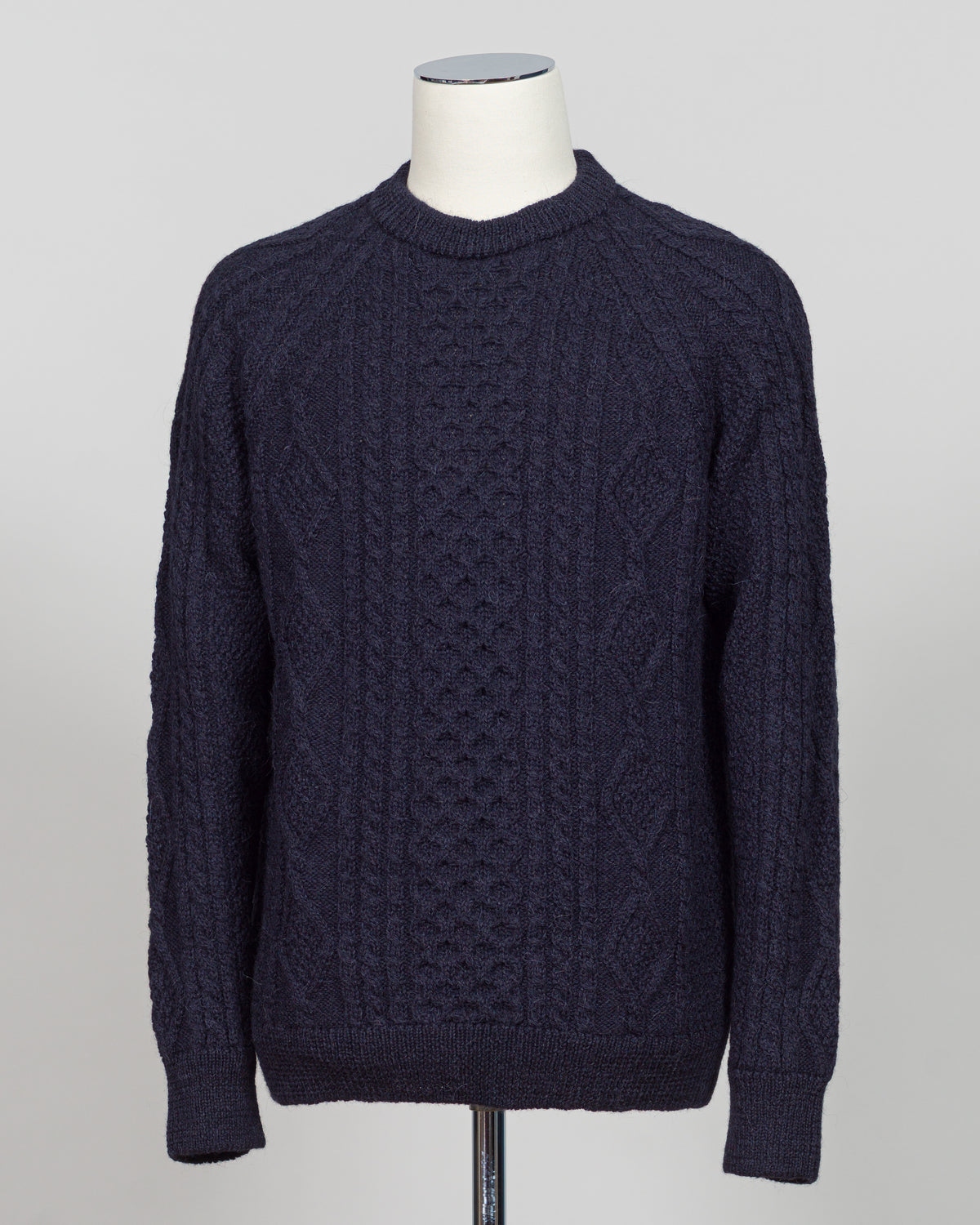 Crafted in collaboration with Casa Isaac, this Aran jumper showcases the timeless appeal of traditional cable knit construction. The deep blue colorway offers versatile styling for both layered and standalone wear. Premium wool blend delivers warmth and durability, while the structured fit maintains its shape through regular wear. A refined staple for the discerning wardrobe.