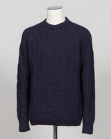 Crafted in collaboration with Casa Isaac, this Aran jumper showcases the timeless appeal of traditional cable knit construction. The deep blue colorway offers versatile styling for both layered and standalone wear. Premium wool blend delivers warmth and durability, while the structured fit maintains its shape through regular wear. A refined staple for the discerning wardrobe.