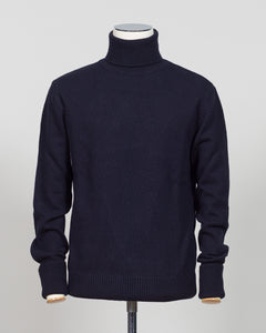 Crafted from premium Italian yarn, the G.R.P. Firenze rollneck knit delivers refined simplicity with architectural precision. The navy tone pairs seamlessly with tailored pieces, while the structured rollneck and clean finish reflect the meticulous construction standards of contemporary menswear. Ideal for layering or worn as a statement piece, this knit bridges casual elegance with wardrobing versatility.