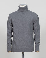 Crafted from premium Italian yarn, the G.R.P. Firenze rollneck knit delivers refined simplicity with architectural precision. The elevated grey tone pairs seamlessly with tailored pieces, while the structured rollneck and clean finish reflect the meticulous construction standards of contemporary menswear. Ideal for layering or worn as a statement piece, this knit bridges casual elegance with wardrobing versatility.