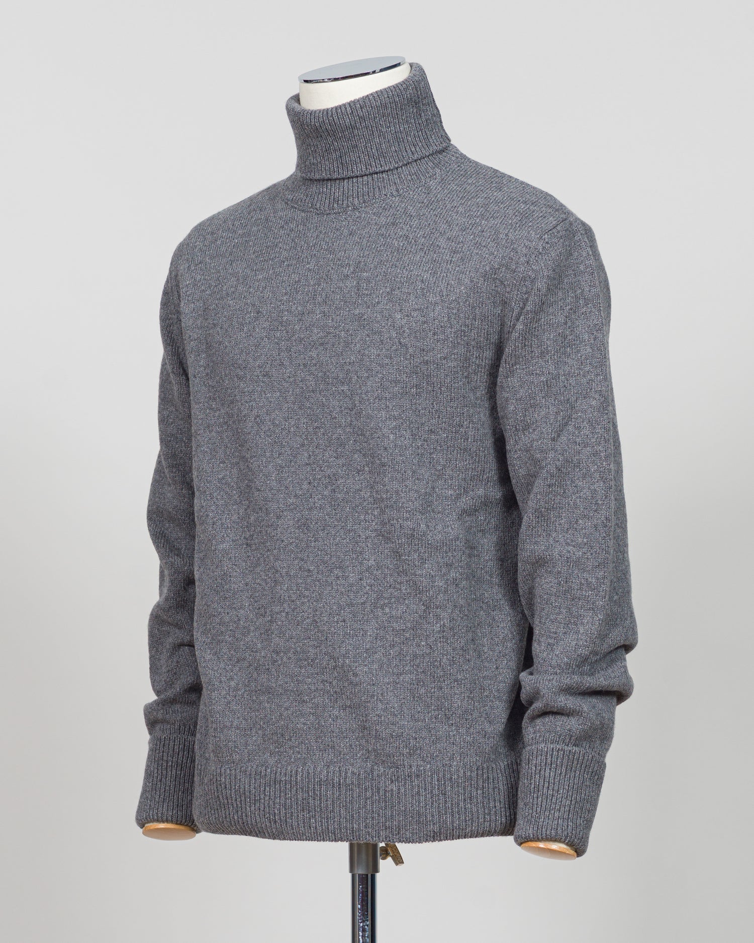 Crafted from premium Italian yarn, the G.R.P. Firenze rollneck knit delivers refined simplicity with architectural precision. The elevated grey tone pairs seamlessly with tailored pieces, while the structured rollneck and clean finish reflect the meticulous construction standards of contemporary menswear. Ideal for layering or worn as a statement piece, this knit bridges casual elegance with wardrobing versatility.