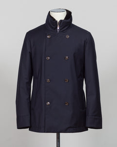 Montecore's double-breasted down jacket combines Italian tailoring precision with practical outerwear design. Navy wool outer with premium down filling delivers warmth without bulk, while structured shoulders and clean lines reflect luxury menswear craftsmanship. Horn buttons and internal quilting detail elevate everyday wear.

Perfect for layering across seasons—wear over knitwear or dress shirts. The relaxed yet refined silhouette suits both smart-casual and dressier occasions. Wind and water-resistant fi