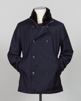 Montecore's double-breasted down jacket combines Italian tailoring precision with practical outerwear design. Navy wool outer with premium down filling delivers warmth without bulk, while structured shoulders and clean lines reflect luxury menswear craftsmanship. Horn buttons and internal quilting detail elevate everyday wear.

Perfect for layering across seasons—wear over knitwear or dress shirts. The relaxed yet refined silhouette suits both smart-casual and dressier occasions. Wind and water-resistant fi