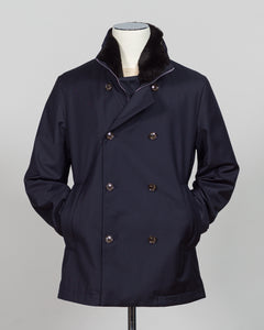 Montecore's double-breasted down jacket combines Italian tailoring precision with practical outerwear design. Navy wool outer with premium down filling delivers warmth without bulk, while structured shoulders and clean lines reflect luxury menswear craftsmanship. Horn buttons and internal quilting detail elevate everyday wear.

Perfect for layering across seasons—wear over knitwear or dress shirts. The relaxed yet refined silhouette suits both smart-casual and dressier occasions. Wind and water-resistant fi