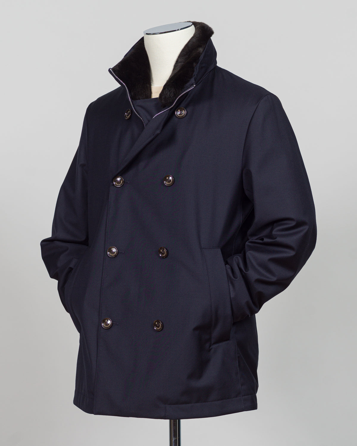 Montecore's double-breasted down jacket combines Italian tailoring precision with practical outerwear design. Navy wool outer with premium down filling delivers warmth without bulk, while structured shoulders and clean lines reflect luxury menswear craftsmanship. Horn buttons and internal quilting detail elevate everyday wear.

Perfect for layering across seasons—wear over knitwear or dress shirts. The relaxed yet refined silhouette suits both smart-casual and dressier occasions. Wind and water-resistant fi