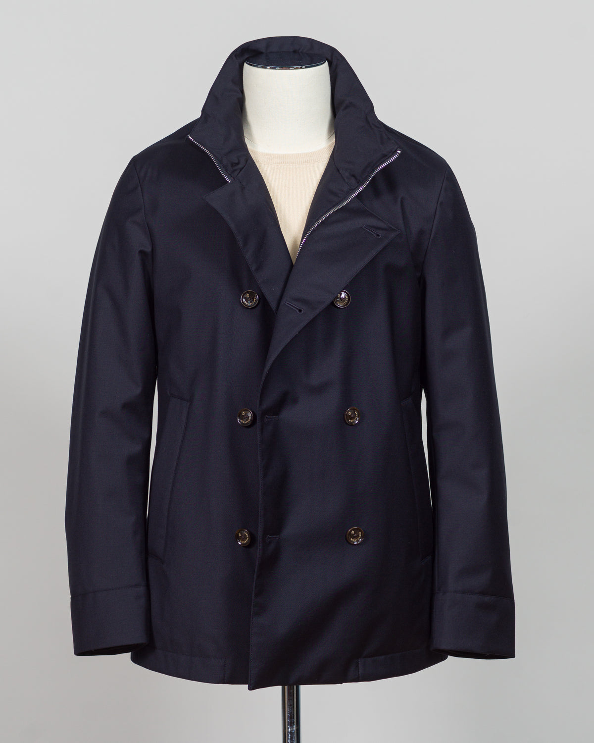 Montecore's double-breasted down jacket combines Italian tailoring precision with practical outerwear design. Navy wool outer with premium down filling delivers warmth without bulk, while structured shoulders and clean lines reflect luxury menswear craftsmanship. Horn buttons and internal quilting detail elevate everyday wear.

Perfect for layering across seasons—wear over knitwear or dress shirts. The relaxed yet refined silhouette suits both smart-casual and dressier occasions. Wind and water-resistant fi