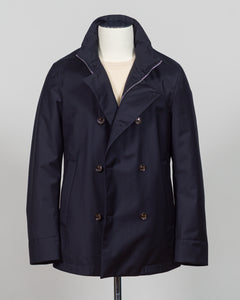 Montecore's double-breasted down jacket combines Italian tailoring precision with practical outerwear design. Navy wool outer with premium down filling delivers warmth without bulk, while structured shoulders and clean lines reflect luxury menswear craftsmanship. Horn buttons and internal quilting detail elevate everyday wear.

Perfect for layering across seasons—wear over knitwear or dress shirts. The relaxed yet refined silhouette suits both smart-casual and dressier occasions. Wind and water-resistant fi