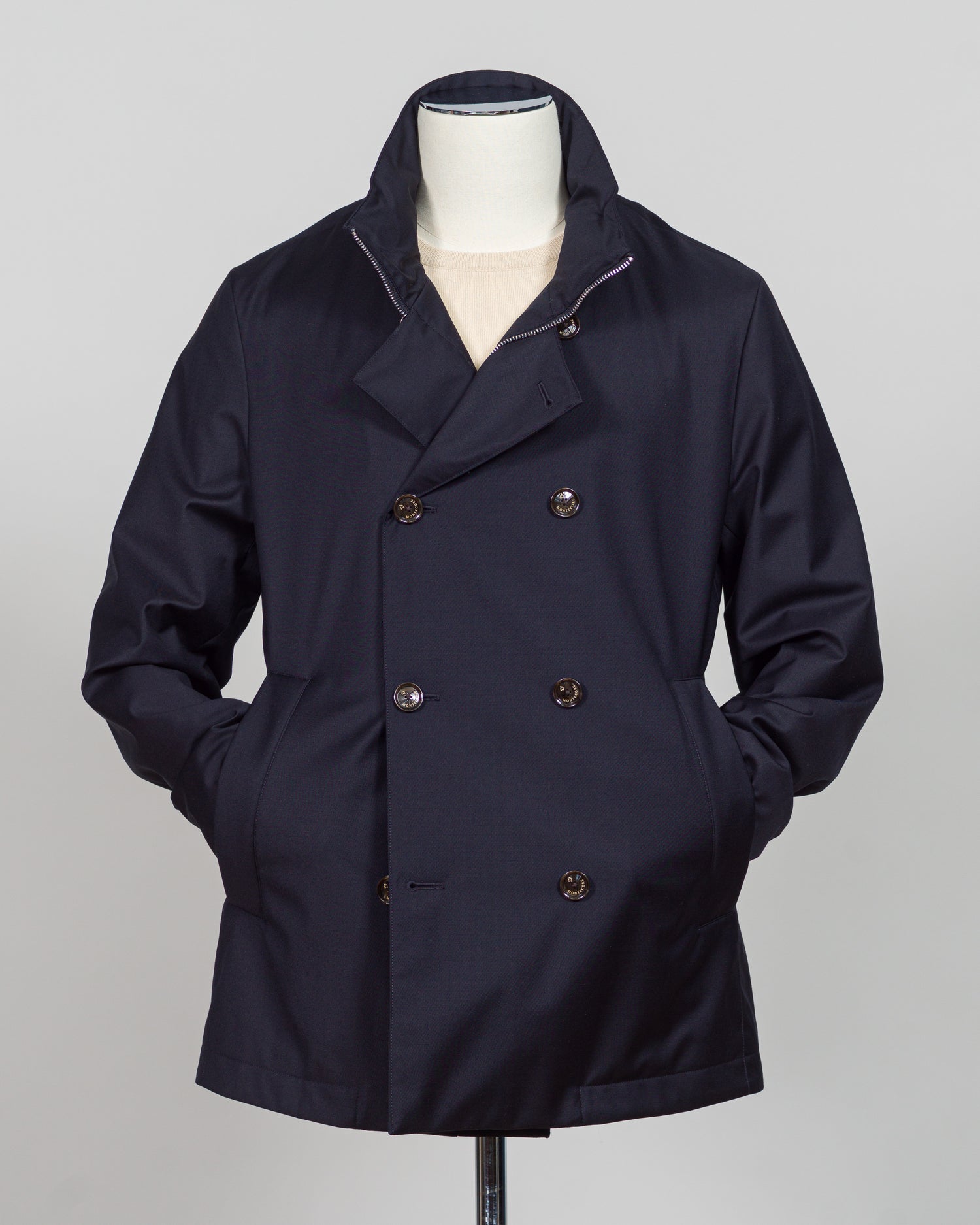 Montecore's double-breasted down jacket combines Italian tailoring precision with practical outerwear design. Navy wool outer with premium down filling delivers warmth without bulk, while structured shoulders and clean lines reflect luxury menswear craftsmanship. Horn buttons and internal quilting detail elevate everyday wear.

Perfect for layering across seasons—wear over knitwear or dress shirts. The relaxed yet refined silhouette suits both smart-casual and dressier occasions. Wind and water-resistant fi