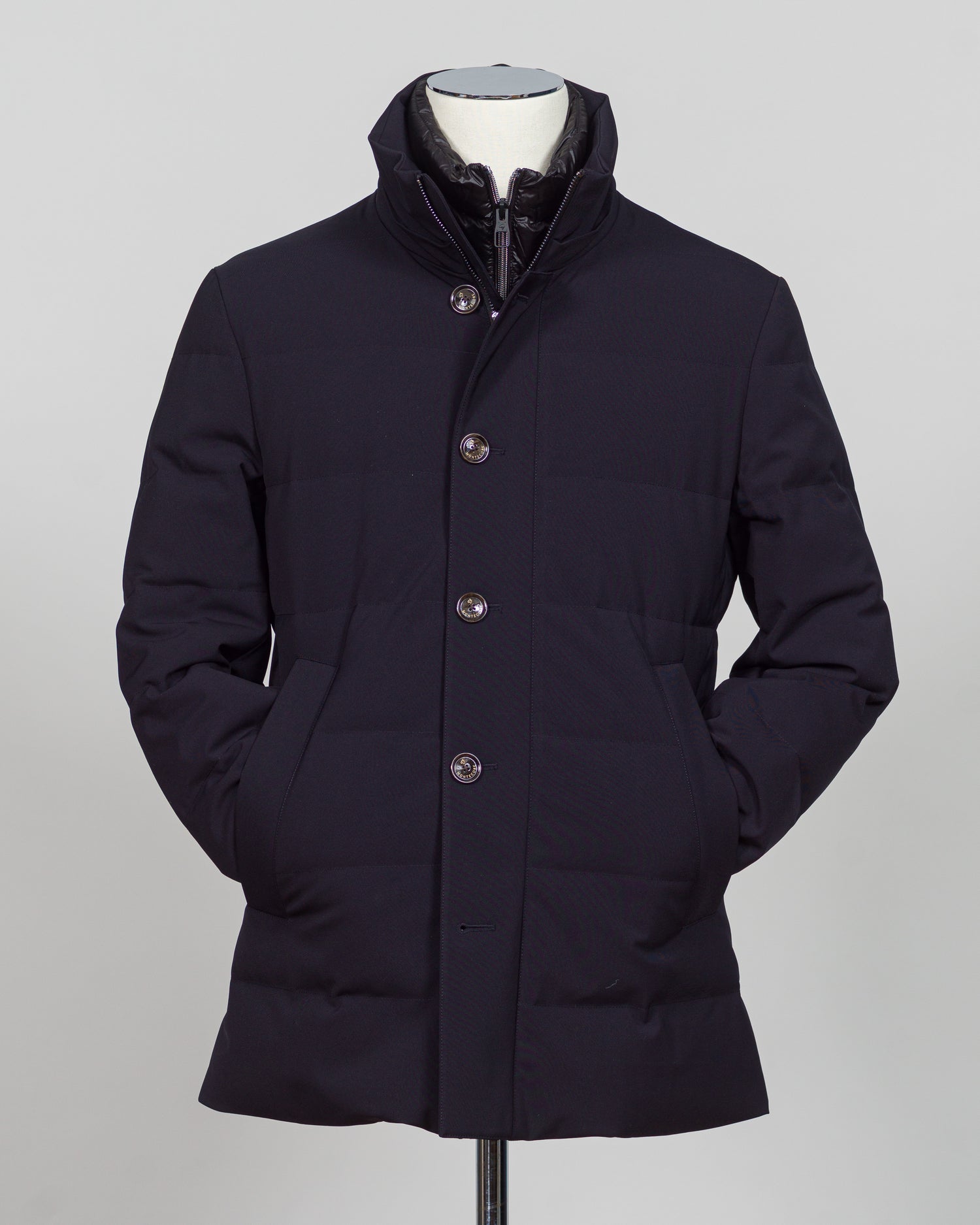 The Montecore Aerotwill Down Jacket combines lightweight insulation with weather-resistant performance. Crafted from premium aerotwill fabric, this navy jacket traps warmth without bulk, making it ideal for layering through transitional seasons or wearing as a standalone piece in mild conditions. The down fill provides responsive loft and compressibility for easy packing and storage. Cut with a refined silhouette that works seamlessly with tailored pieces, this jacket bridges casual functionality and polish