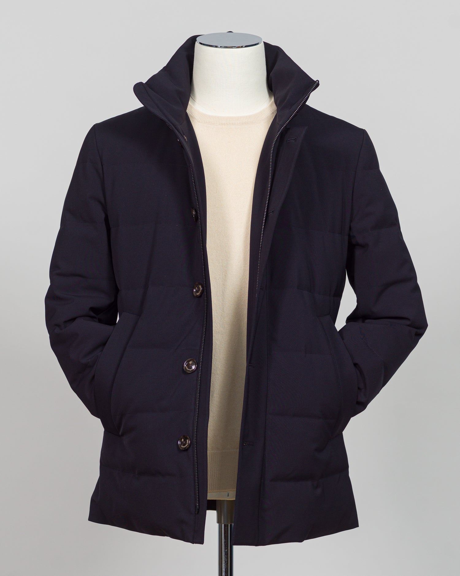 The Montecore Aerotwill Down Jacket combines lightweight insulation with weather-resistant performance. Crafted from premium aerotwill fabric, this navy jacket traps warmth without bulk, making it ideal for layering through transitional seasons or wearing as a standalone piece in mild conditions. The down fill provides responsive loft and compressibility for easy packing and storage. Cut with a refined silhouette that works seamlessly with tailored pieces, this jacket bridges casual functionality and polish