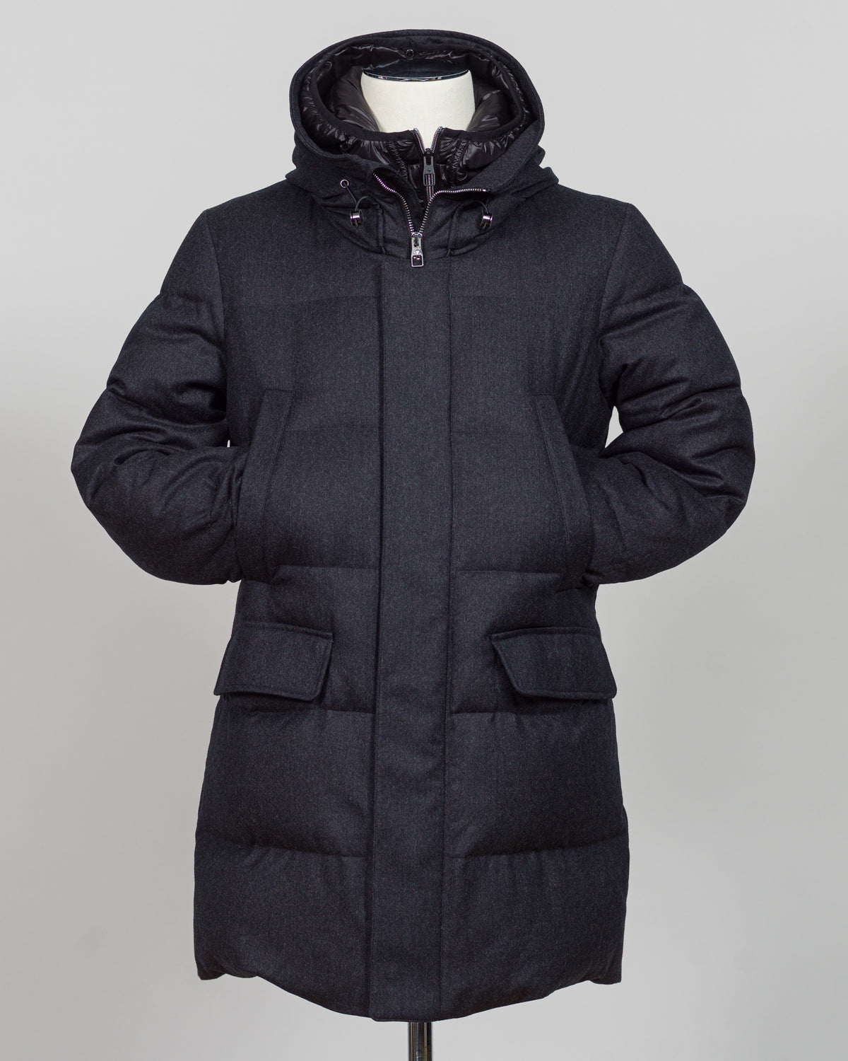 The Montecore VBC Flannel Down Coat delivers refined warmth with understated sophistication. Crafted from premium VBC flannel in deep charcoal grey, this jacket balances structure and comfort for versatile layering across seasons.

Filled with responsibly sourced down insulation, it provides exceptional thermal efficiency without excess bulk. The classic silhouette suits tailored wardrobes—layer it over dress shirts for office wear or pair casually with knitwear for weekend elegance.

VBC's heritage Italian