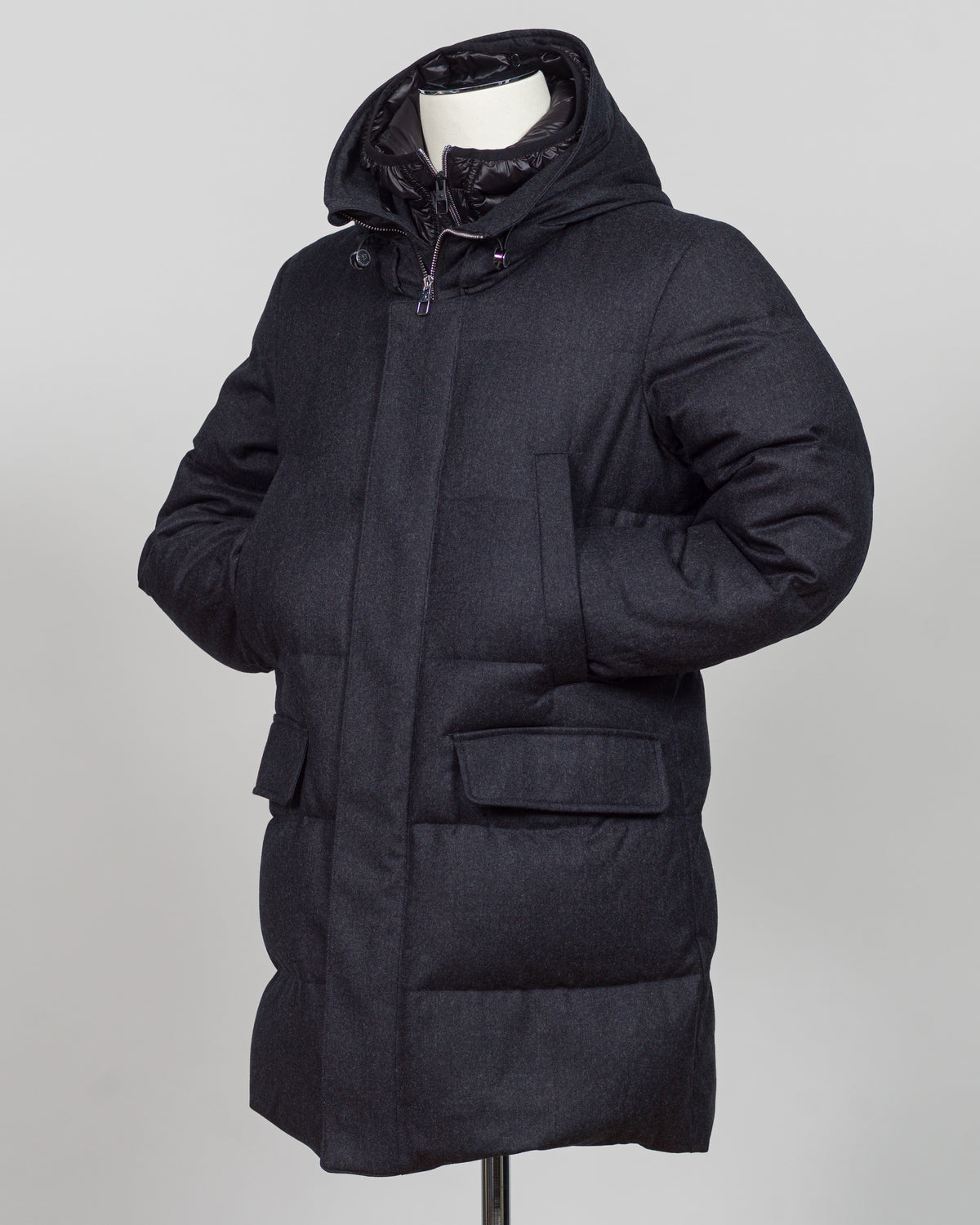 The Montecore VBC Flannel Down Coat delivers refined warmth with understated sophistication. Crafted from premium VBC flannel in deep charcoal grey, this jacket balances structure and comfort for versatile layering across seasons.

Filled with responsibly sourced down insulation, it provides exceptional thermal efficiency without excess bulk. The classic silhouette suits tailored wardrobes—layer it over dress shirts for office wear or pair casually with knitwear for weekend elegance.

VBC's heritage Italian