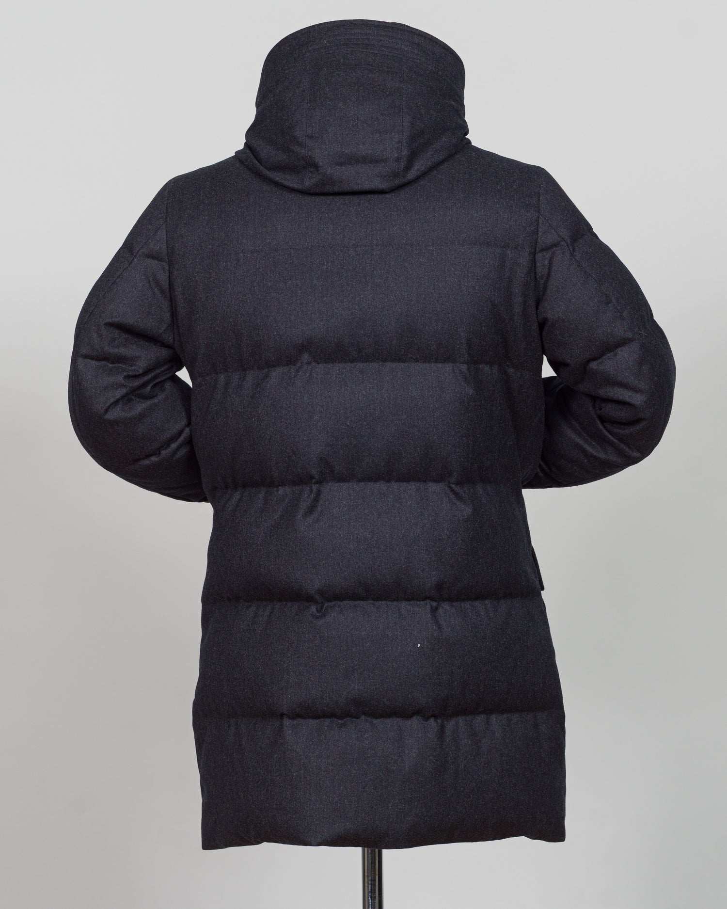The Montecore VBC Flannel Down Coat delivers refined warmth with understated sophistication. Crafted from premium VBC flannel in deep charcoal grey, this jacket balances structure and comfort for versatile layering across seasons.

Filled with responsibly sourced down insulation, it provides exceptional thermal efficiency without excess bulk. The classic silhouette suits tailored wardrobes—layer it over dress shirts for office wear or pair casually with knitwear for weekend elegance.

VBC's heritage Italian
