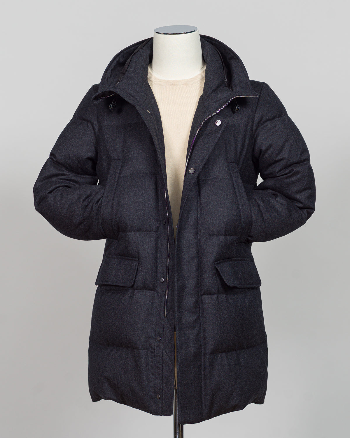The Montecore VBC Flannel Down Coat delivers refined warmth with understated sophistication. Crafted from premium VBC flannel in deep charcoal grey, this jacket balances structure and comfort for versatile layering across seasons.

Filled with responsibly sourced down insulation, it provides exceptional thermal efficiency without excess bulk. The classic silhouette suits tailored wardrobes—layer it over dress shirts for office wear or pair casually with knitwear for weekend elegance.

VBC's heritage Italian