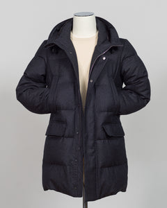 The Montecore VBC Flannel Down Coat delivers refined warmth with understated sophistication. Crafted from premium VBC flannel in deep charcoal grey, this jacket balances structure and comfort for versatile layering across seasons.

Filled with responsibly sourced down insulation, it provides exceptional thermal efficiency without excess bulk. The classic silhouette suits tailored wardrobes—layer it over dress shirts for office wear or pair casually with knitwear for weekend elegance.

VBC's heritage Italian