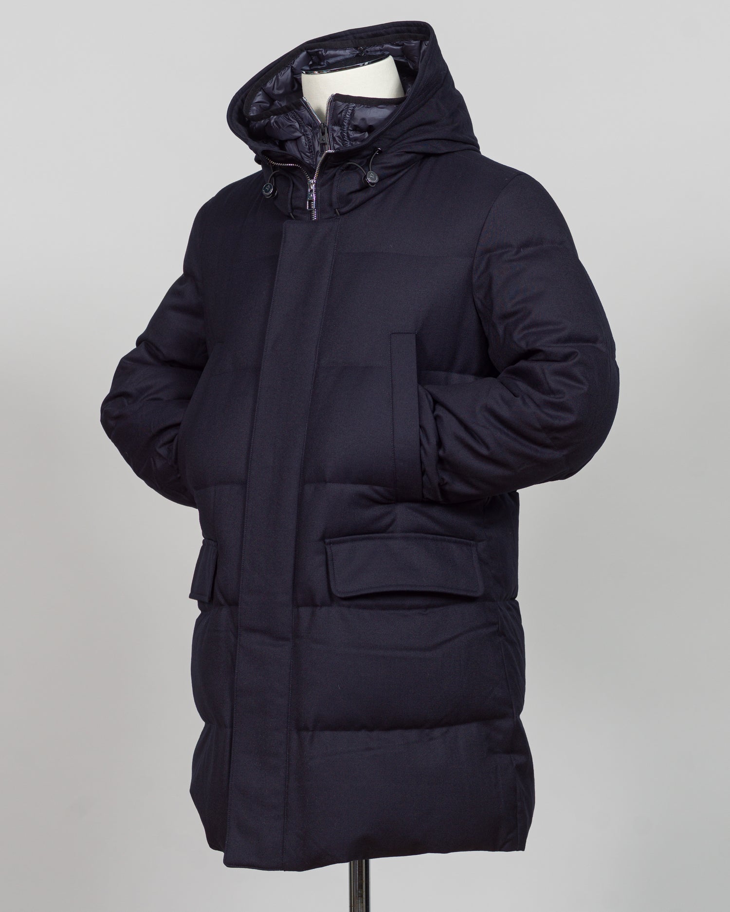 The Montecore VBC Flannel Down Coat delivers refined warmth with understated sophistication. Crafted from premium VBC flannel in navy, this jacket balances structure and comfort for versatile layering across seasons.

Filled with responsibly sourced down insulation, it provides exceptional thermal efficiency without excess bulk. The classic silhouette suits tailored wardrobes—layer it over dress shirts for office wear or pair casually with knitwear for weekend elegance.

VBC's heritage Italian mills ensure 