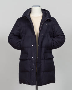 The Montecore VBC Flannel Down Coat delivers refined warmth with understated sophistication. Crafted from premium VBC flannel in navy, this jacket balances structure and comfort for versatile layering across seasons.

Filled with responsibly sourced down insulation, it provides exceptional thermal efficiency without excess bulk. The classic silhouette suits tailored wardrobes—layer it over dress shirts for office wear or pair casually with knitwear for weekend elegance.

VBC's heritage Italian mills ensure 