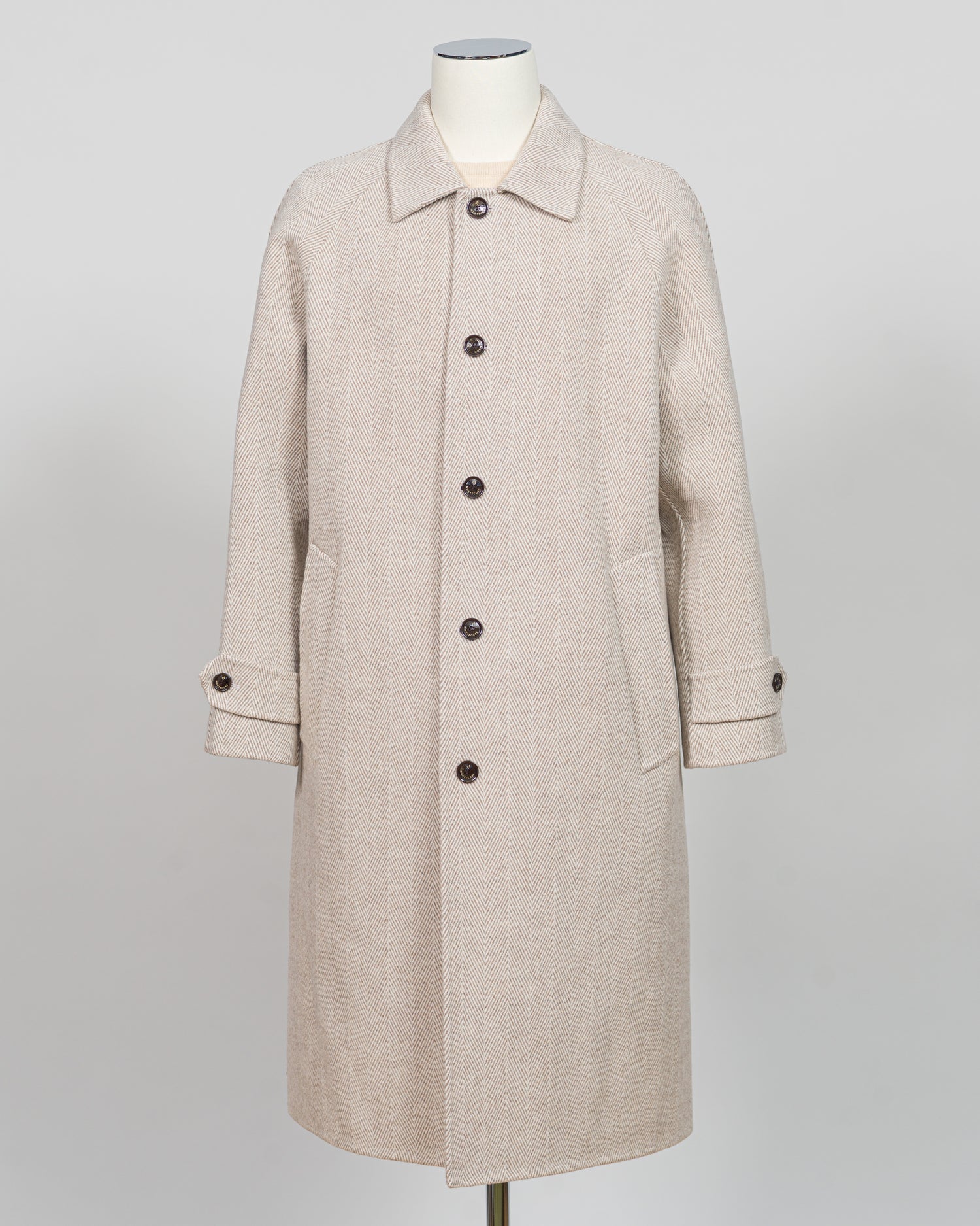 A light beige textured wool coat displayed on a mannequin against a neutral light gray background.