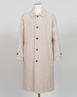 A light beige textured wool coat displayed on a mannequin against a neutral light gray background.