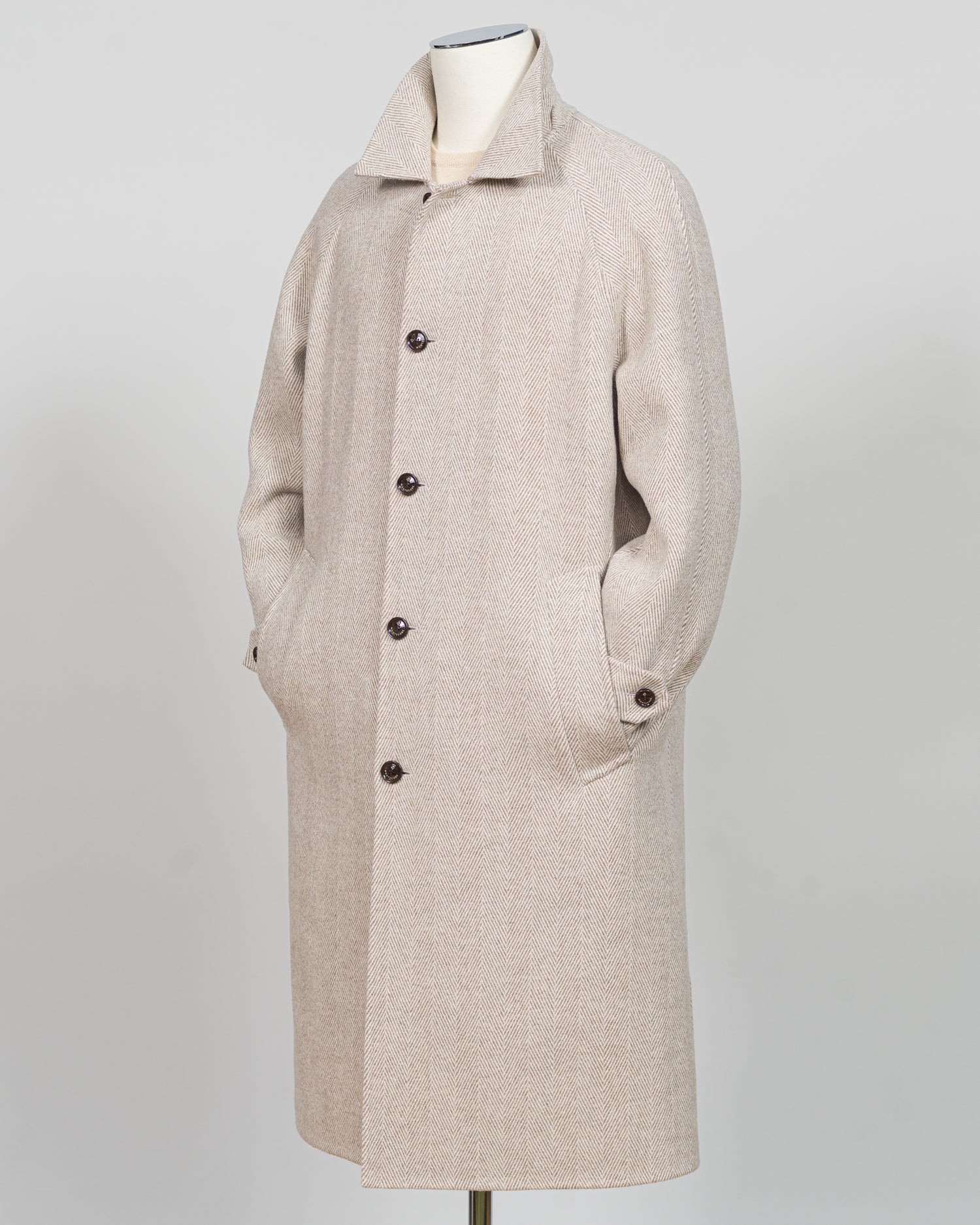 A light beige textured wool-blend coat displayed on a mannequin against a neutral gray background.