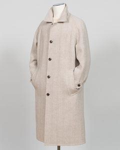 A light beige textured wool-blend coat displayed on a mannequin against a neutral gray background.