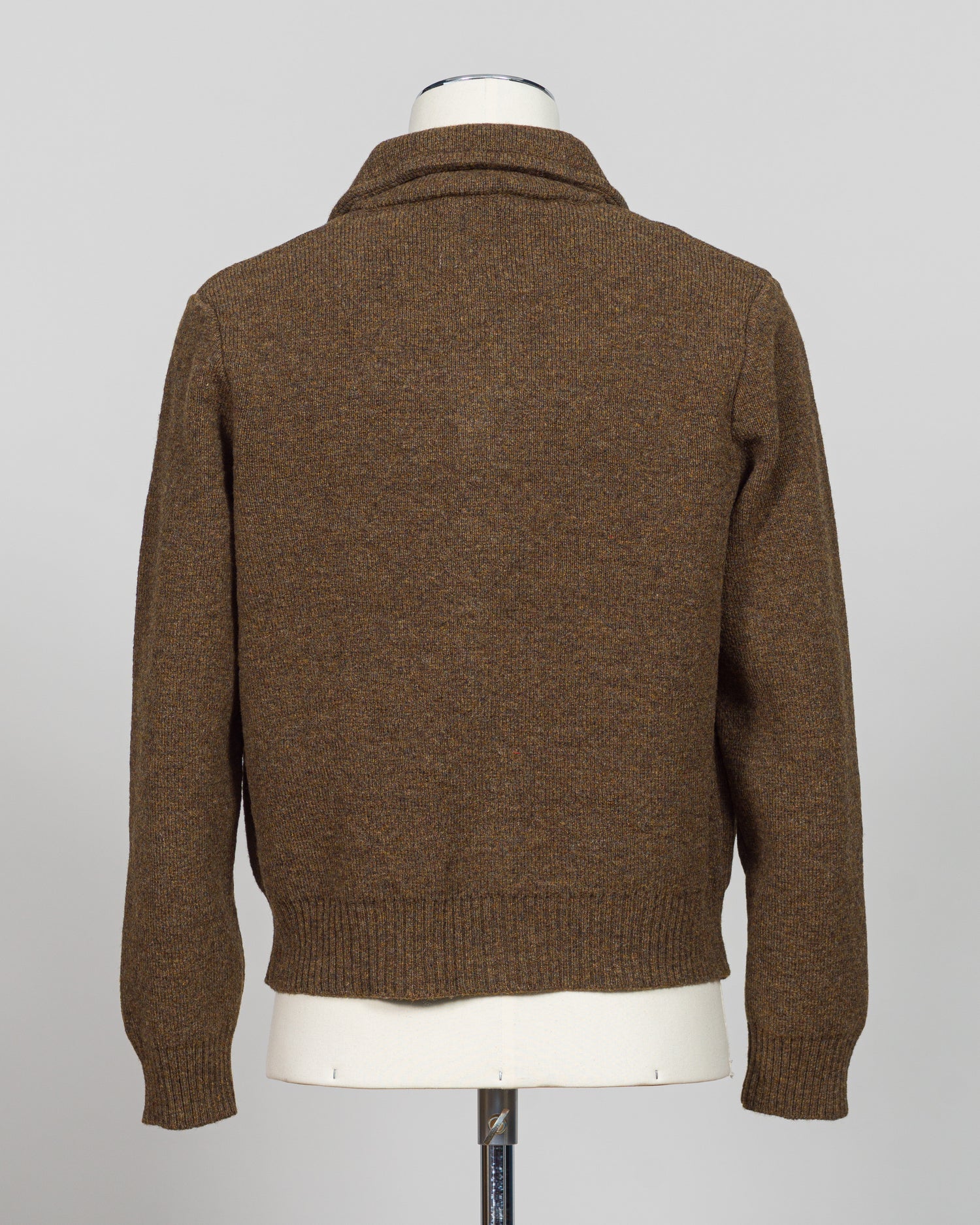 A masterful collaboration between G.R.P. Firenze and Max Rohr, this knitted wool jacket merges Italian craftsmanship with contemporary design. The rich brown tone offers versatile styling across seasons, while the structured knit construction provides both warmth and refined elegance. Perfect for layering or wearing as a statement piece, this jacket embodies the luxury menswear aesthetic with its understated sophistication and impeccable attention to detail.