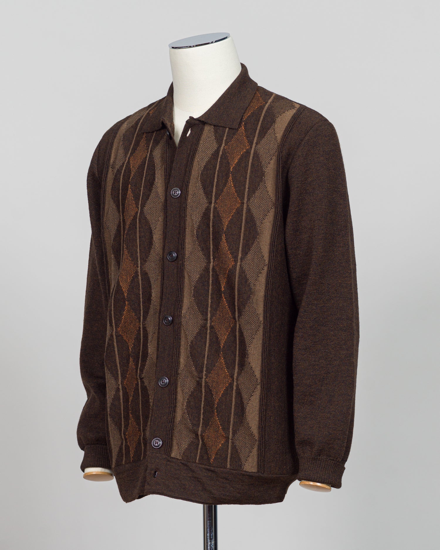 Italian craftsmanship meets timeless design in this G.R.P. Firenze argyle cardigan. The intricate argyle pattern in warm brown tones adds sophisticated visual interest to an elevated everyday piece. Fine knit construction delivers comfort and durability through repeated wear and layering.

Perfect for layering over dress shirts or wearing standalone, this cardigan transitions seamlessly from office to weekend. The classic pattern and neutral colorway pair effortlessly with tailored trousers, jeans, or knitw
