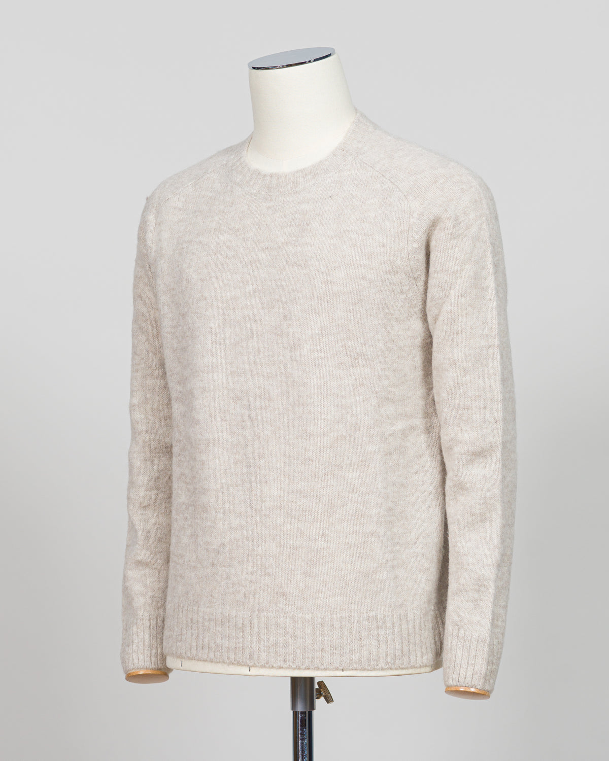 Effortless layering meets understated elegance with the FLY3 Raglan Crewneck Knit. The classic raglan silhouette drapes naturally across the shoulders, creating a relaxed fit that works equally well over a crisp dress shirt or worn solo. Crafted in a neutral oatmeal tone, this piece anchors any wardrobe—from business casual to weekend wear. The crew neckline and premium knit construction ensure lasting comfort and durability, making it a versatile staple for year-round styling.