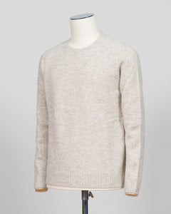 Effortless layering meets understated elegance with the FLY3 Raglan Crewneck Knit. The classic raglan silhouette drapes naturally across the shoulders, creating a relaxed fit that works equally well over a crisp dress shirt or worn solo. Crafted in a neutral oatmeal tone, this piece anchors any wardrobe—from business casual to weekend wear. The crew neckline and premium knit construction ensure lasting comfort and durability, making it a versatile staple for year-round styling.