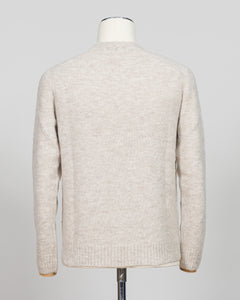 Effortless layering meets understated elegance with the FLY3 Raglan Crewneck Knit. The classic raglan silhouette drapes naturally across the shoulders, creating a relaxed fit that works equally well over a crisp dress shirt or worn solo. Crafted in a neutral oatmeal tone, this piece anchors any wardrobe—from business casual to weekend wear. The crew neckline and premium knit construction ensure lasting comfort and durability, making it a versatile staple for year-round styling.