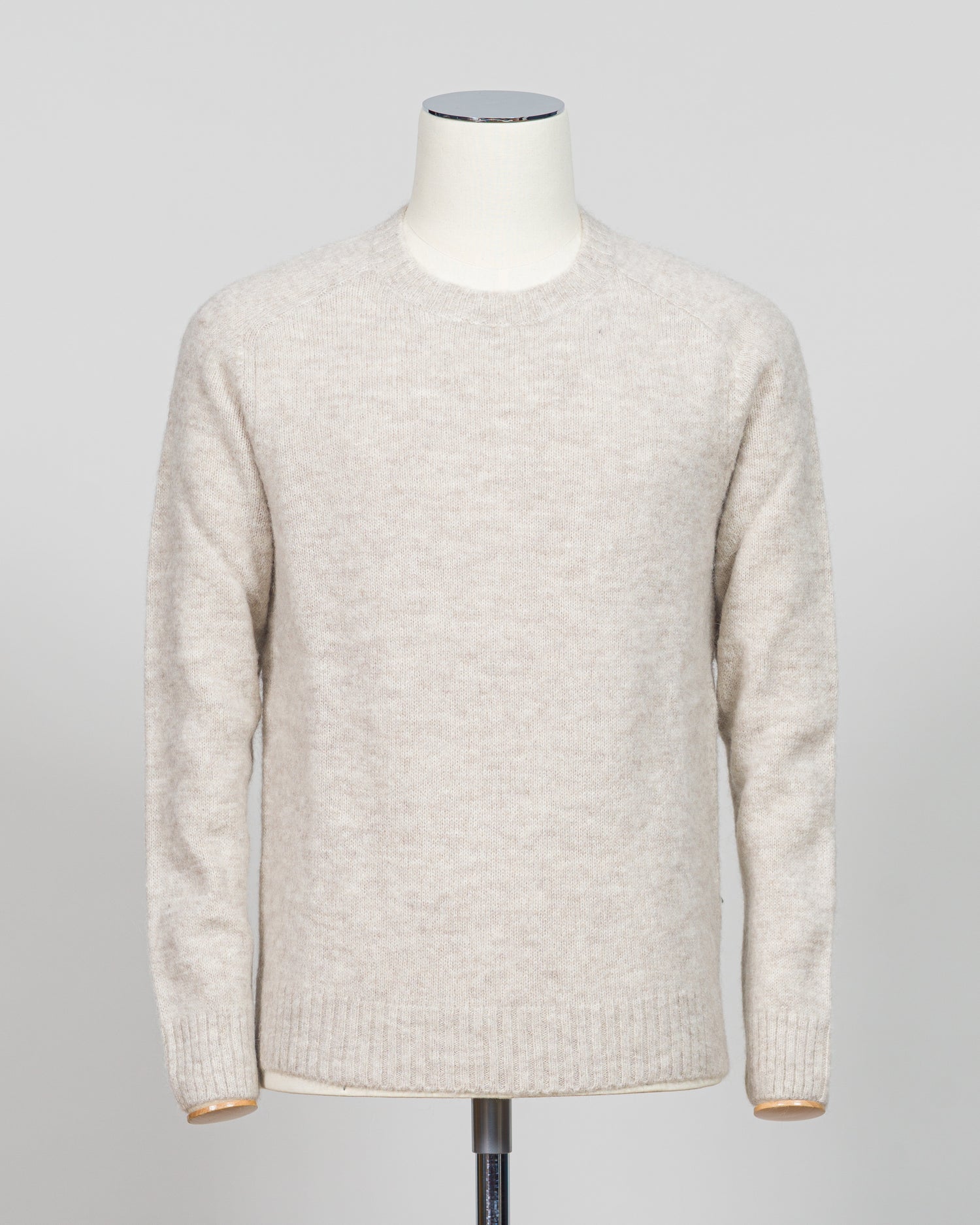 Effortless layering meets understated elegance with the FLY3 Raglan Crewneck Knit. The classic raglan silhouette drapes naturally across the shoulders, creating a relaxed fit that works equally well over a crisp dress shirt or worn solo. Crafted in a neutral oatmeal tone, this piece anchors any wardrobe—from business casual to weekend wear. The crew neckline and premium knit construction ensure lasting comfort and durability, making it a versatile staple for year-round styling.