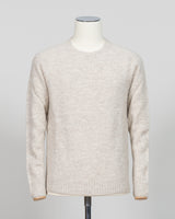 Effortless layering meets understated elegance with the FLY3 Raglan Crewneck Knit. The classic raglan silhouette drapes naturally across the shoulders, creating a relaxed fit that works equally well over a crisp dress shirt or worn solo. Crafted in a neutral oatmeal tone, this piece anchors any wardrobe—from business casual to weekend wear. The crew neckline and premium knit construction ensure lasting comfort and durability, making it a versatile staple for year-round styling.