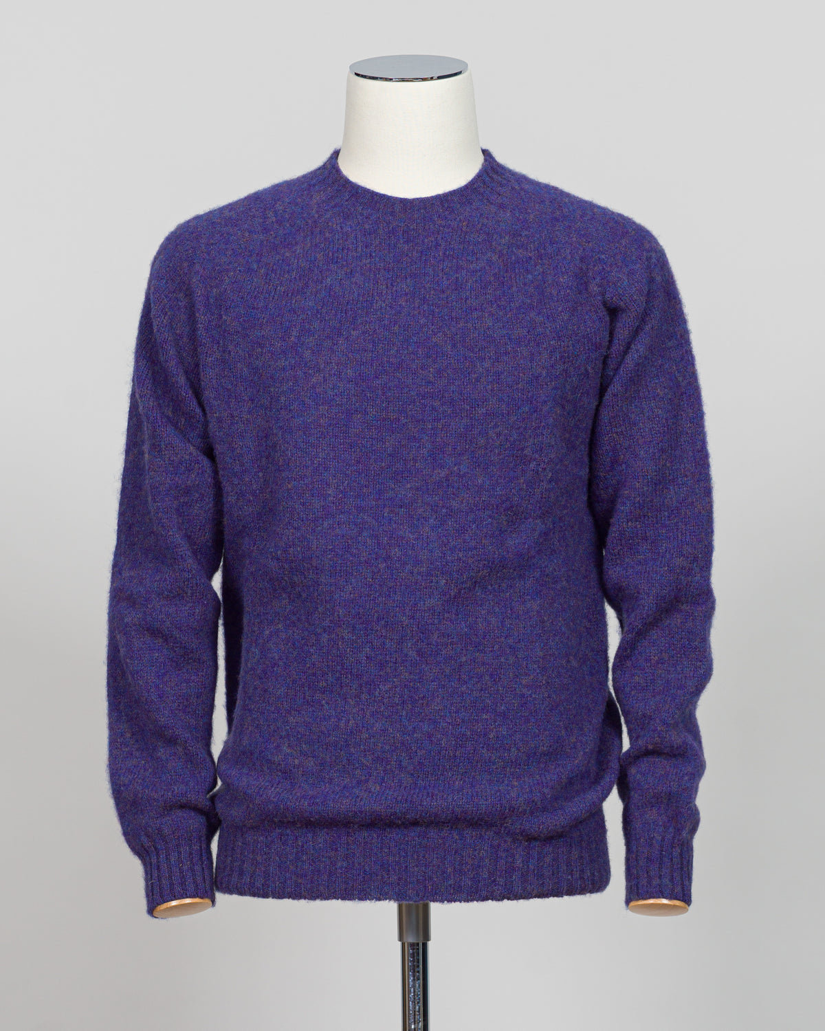 Harley of Scotland's iconic shaggy crew neck sweater in iris. Hand-knitted using traditional Scottish techniques, this piece features a distinctive textured surface that catches light beautifully while delivering exceptional softness against the skin. The relaxed crew neck silhouette works seamlessly as a standalone layer or under tailored blazers for refined versatility.

Premium wool construction provides natural warmth and breathability across seasons. The generous shag pile creates visual depth and tact
