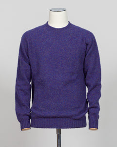 Harley of Scotland's iconic shaggy crew neck sweater in iris. Hand-knitted using traditional Scottish techniques, this piece features a distinctive textured surface that catches light beautifully while delivering exceptional softness against the skin. The relaxed crew neck silhouette works seamlessly as a standalone layer or under tailored blazers for refined versatility.

Premium wool construction provides natural warmth and breathability across seasons. The generous shag pile creates visual depth and tact