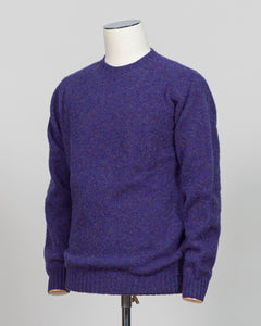Harley of Scotland's iconic shaggy crew neck sweater in iris. Hand-knitted using traditional Scottish techniques, this piece features a distinctive textured surface that catches light beautifully while delivering exceptional softness against the skin. The relaxed crew neck silhouette works seamlessly as a standalone layer or under tailored blazers for refined versatility.

Premium wool construction provides natural warmth and breathability across seasons. The generous shag pile creates visual depth and tact