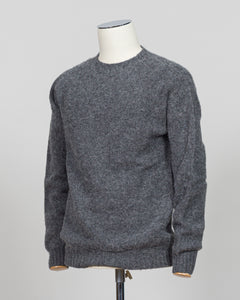 Harley of Scotland's iconic shaggy crew neck sweater in basalt. Hand-knitted using traditional Scottish techniques, this piece features a distinctive textured surface that catches light beautifully while delivering exceptional softness against the skin. The relaxed crew neck silhouette works seamlessly as a standalone layer or under tailored blazers for refined versatility.

Premium wool construction provides natural warmth and breathability across seasons. The generous shag pile creates visual depth and ta