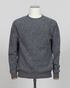 Harley of Scotland's iconic shaggy crew neck sweater in basalt. Hand-knitted using traditional Scottish techniques, this piece features a distinctive textured surface that catches light beautifully while delivering exceptional softness against the skin. The relaxed crew neck silhouette works seamlessly as a standalone layer or under tailored blazers for refined versatility.

Premium wool construction provides natural warmth and breathability across seasons. The generous shag pile creates visual depth and ta