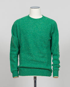 Harley of Scotland's iconic shaggy crew neck sweater in evergreen. Hand-knitted using traditional Scottish techniques, this piece features a distinctive textured surface that catches light beautifully while delivering exceptional softness against the skin. The relaxed crew neck silhouette works seamlessly as a standalone layer or under tailored blazers for refined versatility.

Premium wool construction provides natural warmth and breathability across seasons. The generous shag pile creates visual depth and