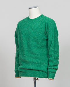 Harley of Scotland's iconic shaggy crew neck sweater in evergreen. Hand-knitted using traditional Scottish techniques, this piece features a distinctive textured surface that catches light beautifully while delivering exceptional softness against the skin. The relaxed crew neck silhouette works seamlessly as a standalone layer or under tailored blazers for refined versatility.

Premium wool construction provides natural warmth and breathability across seasons. The generous shag pile creates visual depth and