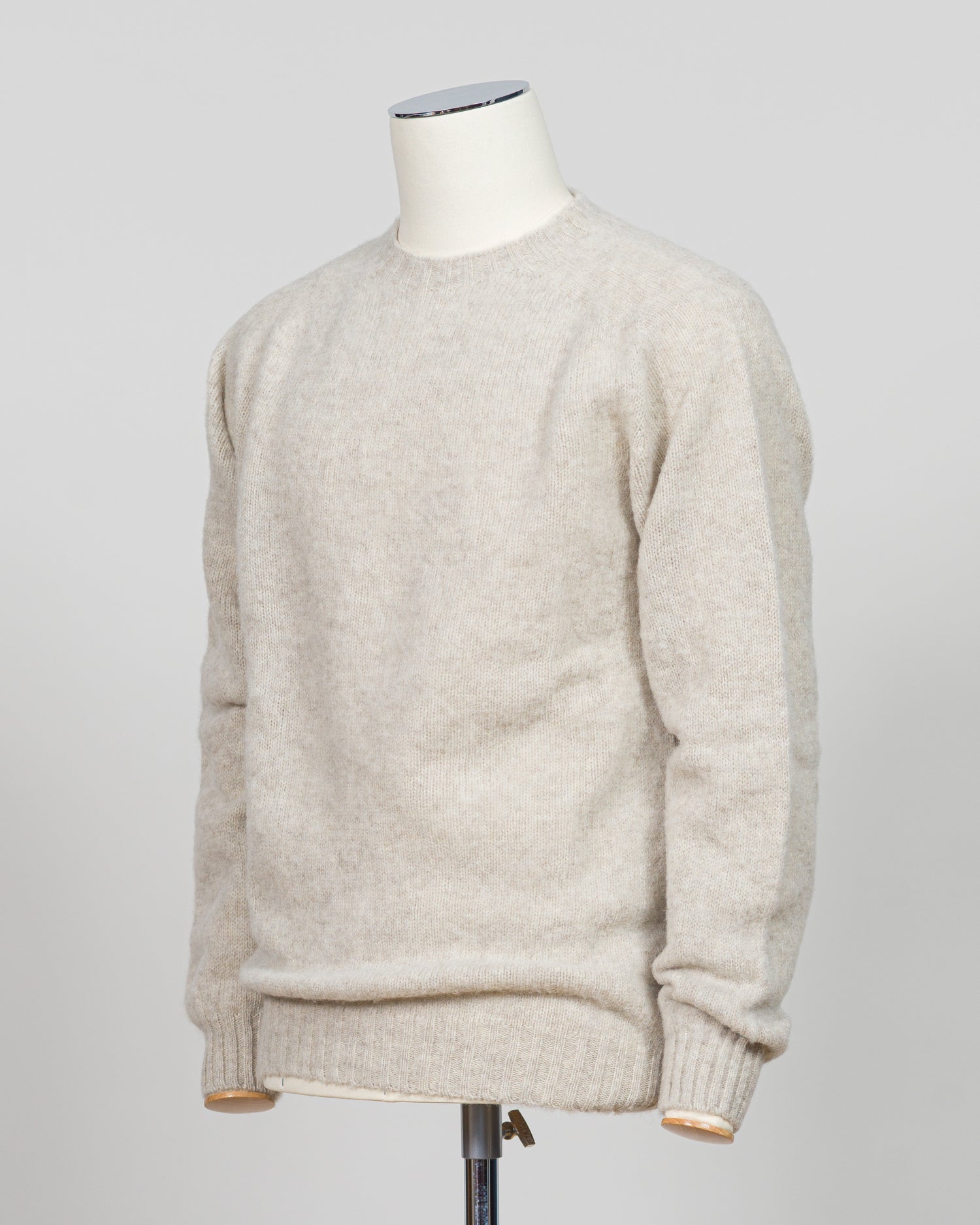 Harley of Scotland's iconic shaggy crew neck sweater in basalt. Hand-knitted using traditional Scottish techniques, this piece features a distinctive textured surface that catches light beautifully while delivering exceptional softness against the skin. The relaxed crew neck silhouette works seamlessly as a standalone layer or under tailored blazers for refined versatility.

Premium wool construction provides natural warmth and breathability across seasons. The generous shag pile creates visual depth and ta