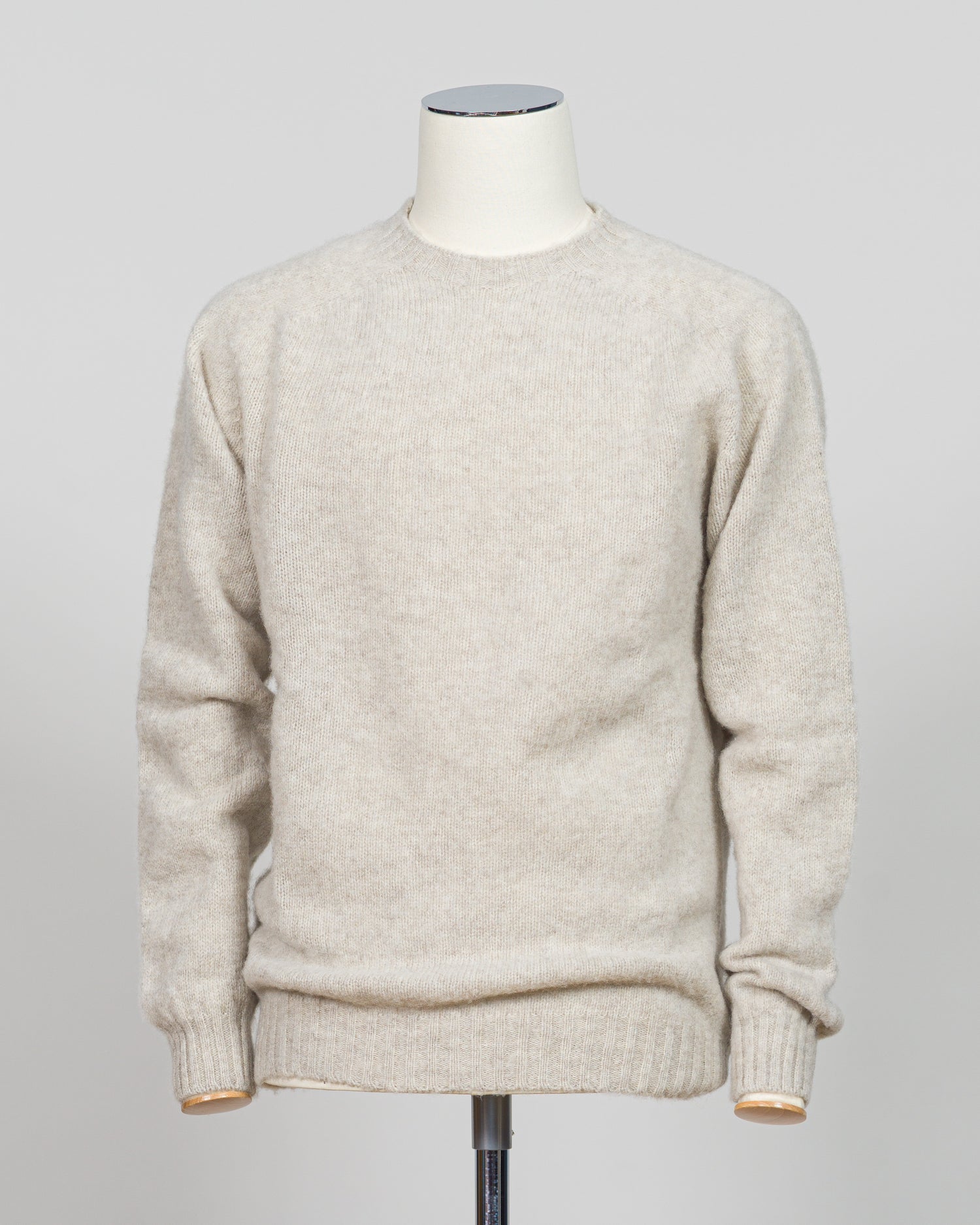 Harley of Scotland's iconic shaggy crew neck sweater in basalt. Hand-knitted using traditional Scottish techniques, this piece features a distinctive textured surface that catches light beautifully while delivering exceptional softness against the skin. The relaxed crew neck silhouette works seamlessly as a standalone layer or under tailored blazers for refined versatility.

Premium wool construction provides natural warmth and breathability across seasons. The generous shag pile creates visual depth and ta