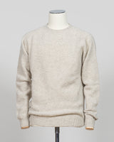 Harley of Scotland's iconic shaggy crew neck sweater in basalt. Hand-knitted using traditional Scottish techniques, this piece features a distinctive textured surface that catches light beautifully while delivering exceptional softness against the skin. The relaxed crew neck silhouette works seamlessly as a standalone layer or under tailored blazers for refined versatility.

Premium wool construction provides natural warmth and breathability across seasons. The generous shag pile creates visual depth and ta