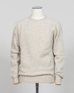 Harley of Scotland's iconic shaggy crew neck sweater in basalt. Hand-knitted using traditional Scottish techniques, this piece features a distinctive textured surface that catches light beautifully while delivering exceptional softness against the skin. The relaxed crew neck silhouette works seamlessly as a standalone layer or under tailored blazers for refined versatility.

Premium wool construction provides natural warmth and breathability across seasons. The generous shag pile creates visual depth and ta