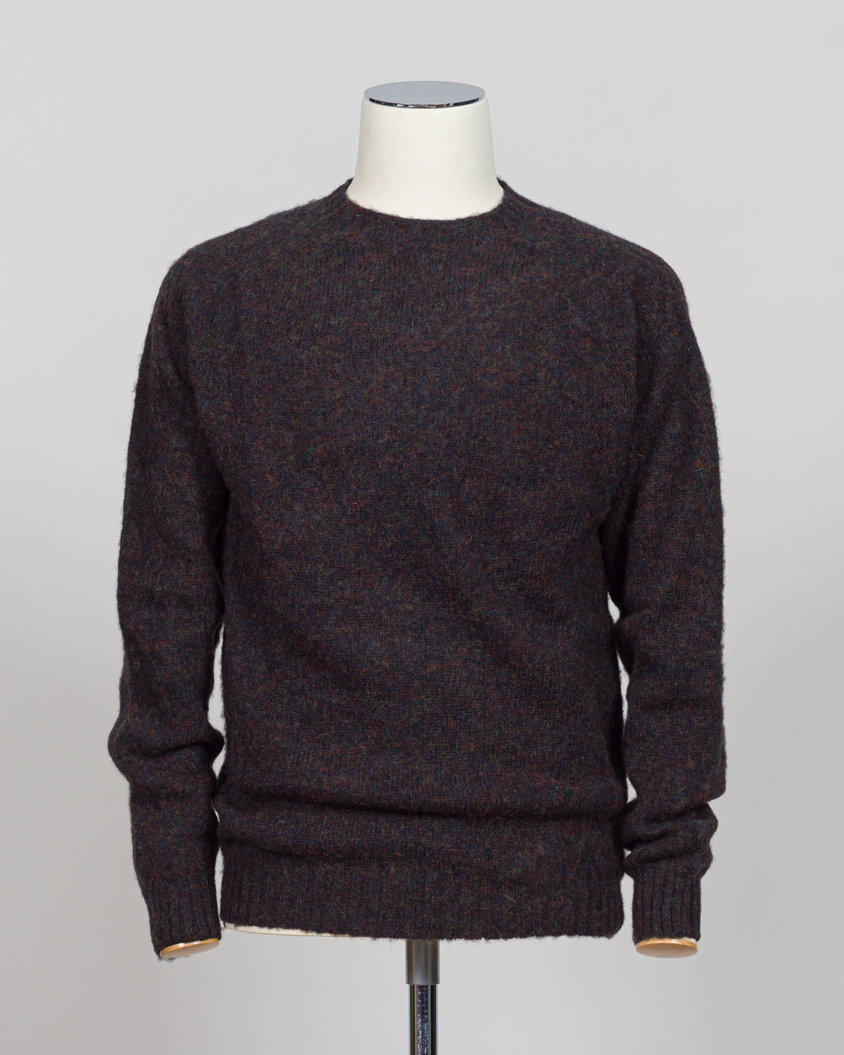 Harley of Scotland's iconic shaggy crew neck sweater in volcano. Hand-knitted using traditional Scottish techniques, this piece features a distinctive textured surface that catches light beautifully while delivering exceptional softness against the skin. The relaxed crew neck silhouette works seamlessly as a standalone layer or under tailored blazers for refined versatility.

Premium wool construction provides natural warmth and breathability across seasons. The generous shag pile creates visual depth and t